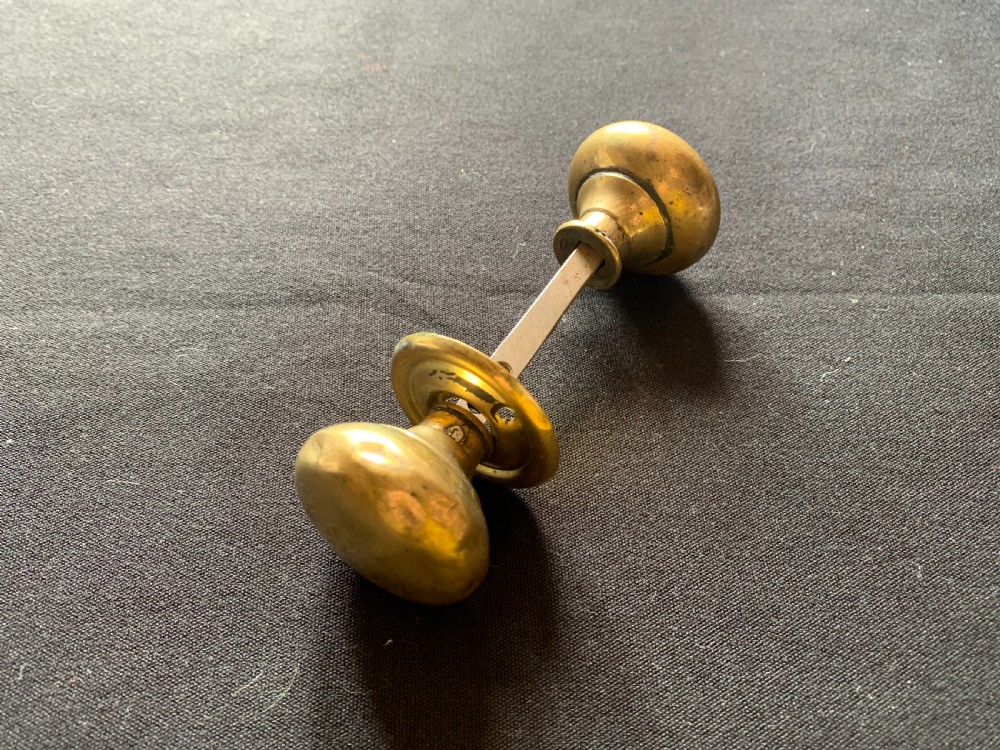 one pair of brass georgian rim lock door knobs