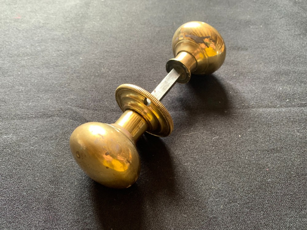 one pair of brass georgian rim lock door knobs