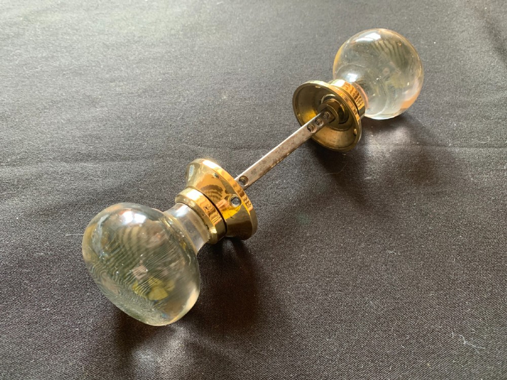 one pair of brass glass regency door knobs